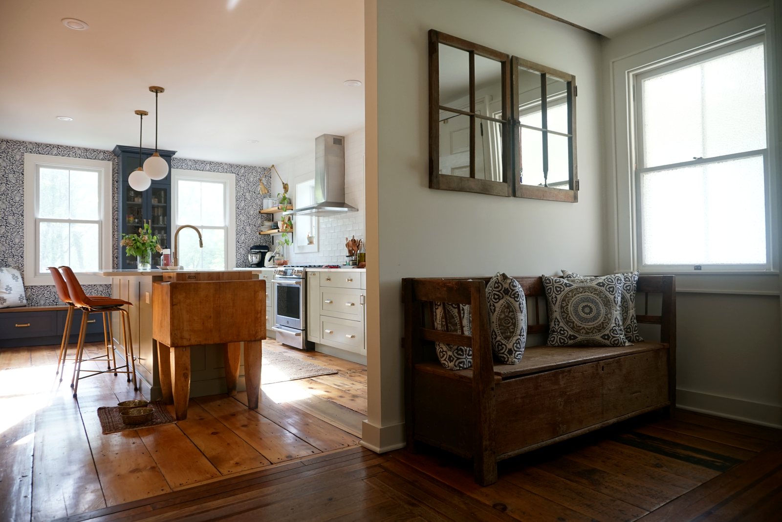 Kitchen with a vintage wooden bench and restored wide-plank floors: 1790 Farmhouse Renovation, Milton NY